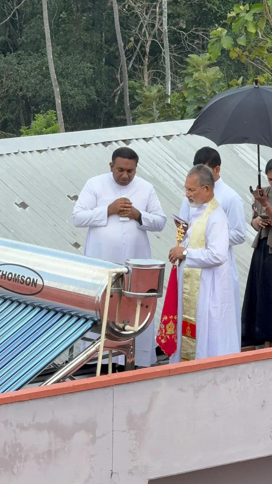 A closer view of clergy conducting a blessing ceremony at Mother Teresa Home.